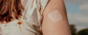 HRT patch on womans arm